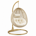 Fauteuil suspendu en rotin avec coussin beige et support métallique doré